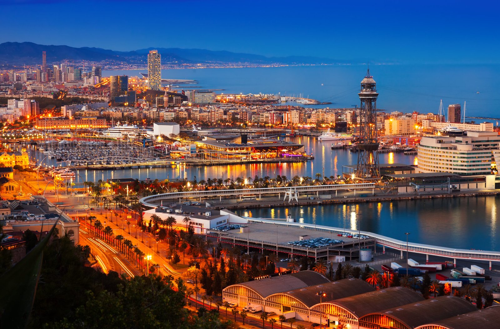 Barcelona harbor, large cruise ship, city buildings and boats, twilight blue skyline, editorial travel photo, no people.